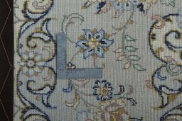 Backside of handmade New Kashan rug showing knot structure and weave density