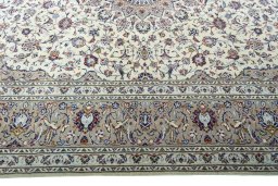 Corner detail of 2000s Kashan rug showing border pattern and Wool pile
