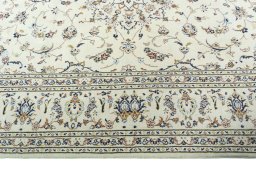 Corner detail of 2000s Kashan rug showing border pattern and Wool pile