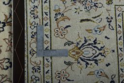 Backside of handmade 2000s Kashan rug showing knot structure and weave density