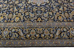 Corner detail of 2000s Kashan rug showing border pattern and Wool pile