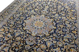 Backside of handmade 2000s Kashan rug showing knot structure and weave density