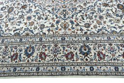 Corner detail of 2000s Kashan rug showing border pattern and Wool pile