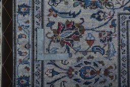 Backside of handmade 2000s Kashan rug showing knot structure and weave density