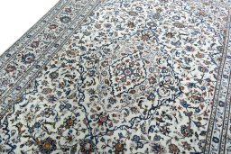 Backside of handmade 2000s Kashan rug showing knot structure and weave density