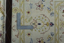 Backside of handmade New Kashan rug showing knot structure and weave density