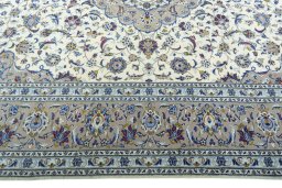Corner detail of 2000s Kashan rug showing border pattern and Wool pile