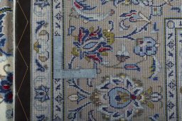 Backside of handmade 2000s Kashan rug showing knot structure and weave density