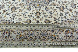 Corner detail of 2000s Kashan rug showing border pattern and Wool pile