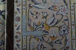 Backside of handmade 2000s Kashan rug showing knot structure and weave density