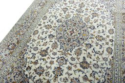 Backside of handmade 2000s Kashan rug showing knot structure and weave density