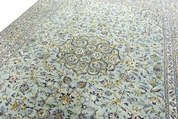 Backside of handmade 2000s Kashan rug showing knot structure and weave density