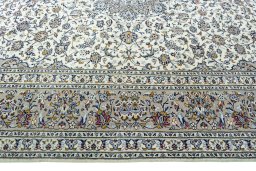 Corner detail of 2000s Kashan rug showing border pattern and Wool pile