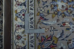 Backside of handmade 2000s Kashan rug showing knot structure and weave density