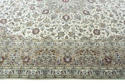Corner detail of 2000s Kashan rug showing border pattern and Wool pile