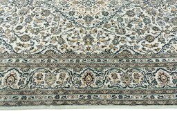 Corner detail of 2000s Kashan rug showing border pattern and Wool pile