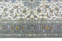 Corner detail of 2000s Kashan rug showing border pattern and Wool pile