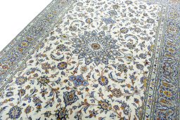 Backside of handmade 2000s Kashan rug showing knot structure and weave density