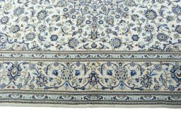 Corner detail of 2000s Kashan rug showing border pattern and Wool pile