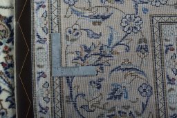 Backside of handmade 2000s Kashan rug showing knot structure and weave density