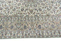 Corner detail of 2000s Kashan rug showing border pattern and Wool pile