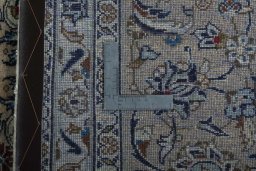 Backside of handmade 2000s Kashan rug showing knot structure and weave density