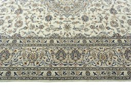 Corner detail of 2000s Kashan rug showing border pattern and Wool pile