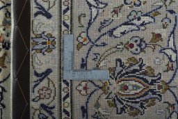 Backside of handmade 2000s Kashan rug showing knot structure and weave density