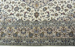 Corner detail of 2000s Kashan rug showing border pattern and Wool pile
