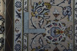 Backside of handmade 2000s Kashan rug showing knot structure and weave density