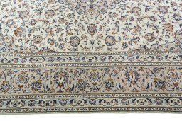 Corner detail of 2000s Kashan rug showing border pattern and Wool pile