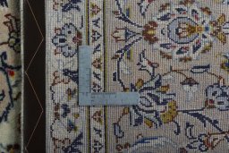 Backside of handmade 2000s Kashan rug showing knot structure and weave density