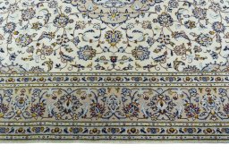 Corner detail of 2000s Kashan rug showing border pattern and Wool pile