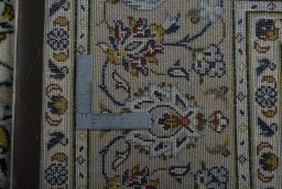 Backside of handmade 2000s Kashan rug showing knot structure and weave density