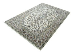 Corner detail of 2000s Kashan rug showing border pattern and Wool pile