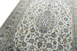 Backside of handmade 2000s Kashan rug showing knot structure and weave density