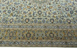Corner detail of 2000s Kashan rug showing border pattern and Wool pile
