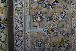 Backside of handmade 2000s Kashan rug showing knot structure and weave density