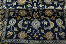 Corner detail of 2000s Kashan rug showing border pattern and Wool pile