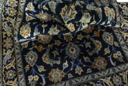 Close-up detail of 2000s Kashan rug from Iran / Persia showing Wool weave