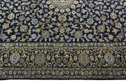 Corner detail of 2000s Kashan rug showing border pattern and Wool pile