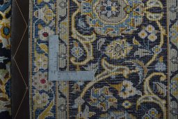 Backside of handmade 2000s Kashan rug showing knot structure and weave density