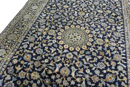 Backside of handmade 2000s Kashan rug showing knot structure and weave density