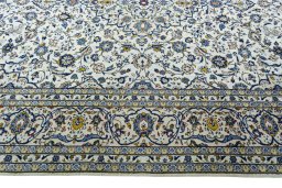 Corner detail of 2000s Kashan rug showing border pattern and Wool pile