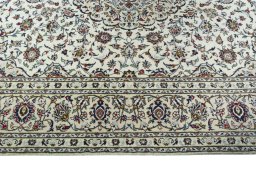 Corner detail of 2000s Kashan rug showing border pattern and Wool pile