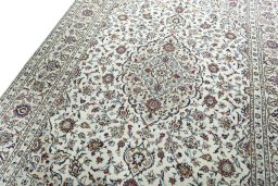 Backside of handmade 2000s Kashan rug showing knot structure and weave density