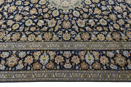 Corner detail of 2000s Kashan rug showing border pattern and Wool pile