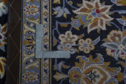 Backside of handmade 2000s Kashan rug showing knot structure and weave density