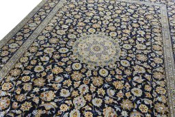 Backside of handmade 2000s Kashan rug showing knot structure and weave density