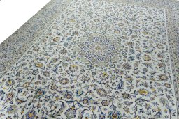 Backside of handmade 2000s Kashan rug showing knot structure and weave density